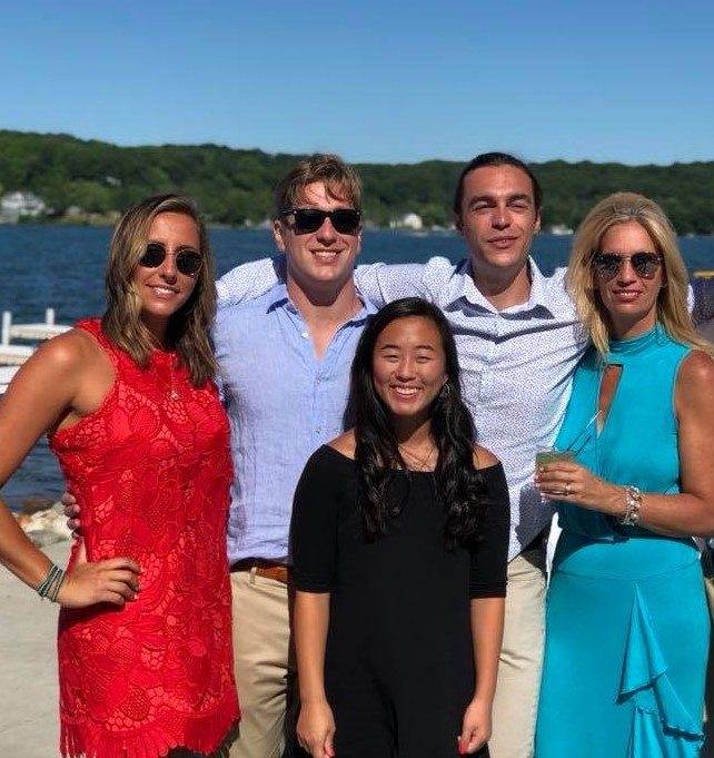 A picture of Luanne and family in front of a lake. 